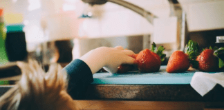 Creating Healthy Food Habits for Babies + Children A toddler reaches to grab some fresh fruit