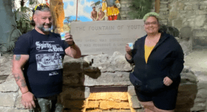 A man and woman stand in front of the Fountain of Youth