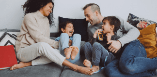 A Thank You to the Partner Who Carries Their Weight in Parenting A family hanging out a laughing together