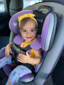 child safely strapped in car seat