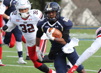 A football player runs with the ball during a play