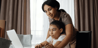 A mom helps her daughter with her school work