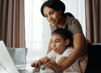 A mom helps her daughter with her school work
