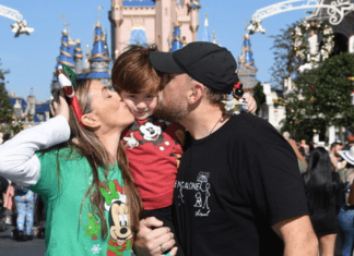 Sandra and her family pose for a photo at Magic Kingdom