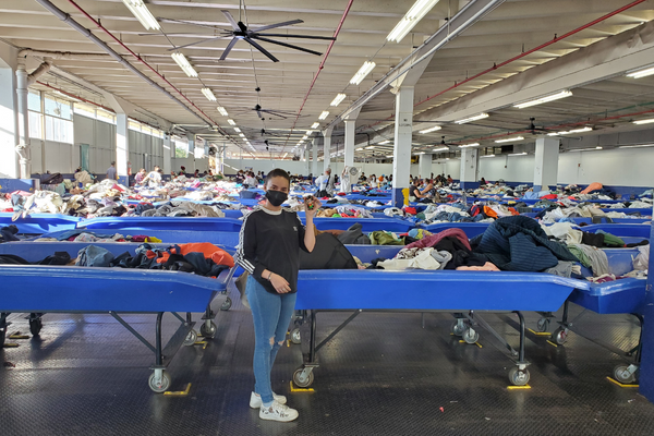 Image: A woman poses for a photo at the Goodwill Outlet