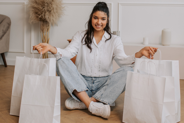 Image: A woman holding large paper shopping bags