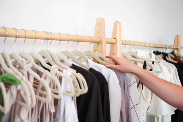 Image: A woman organizing clothes in a closet