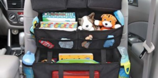 Image: A seatback organizer with water bottles, toys, and other essentials for the car