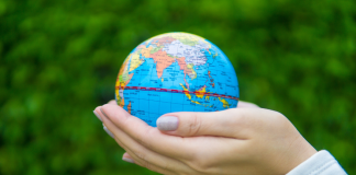 Image: Hands holding a miniature globe