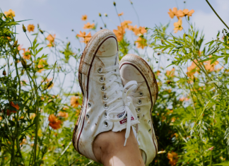 Image: Crossed ankles in a field of flowers