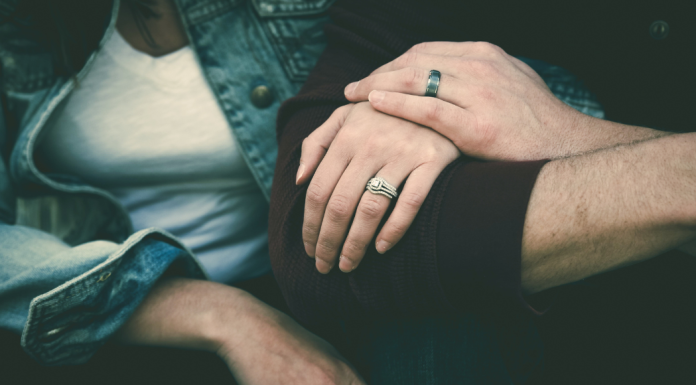 Image: A married couple sitting together, arm in arm