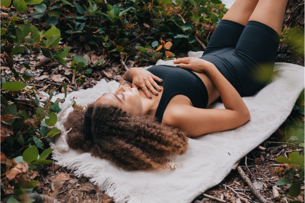 Image: A woman rests on a yoga mat