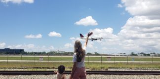 Summer Activities: 5 Different Things to Try With Kids in Miami Image: A mother and son wave to an airplane as it lands at MIA