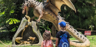 Image: Two kids enjoying the Dragons & Mythical Creatures exhibit at Fairchild Tropical Botanic Garden