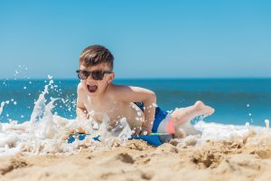 Image: A little boy skim boarding