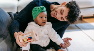 Image: A dad plays with his toddler-aged daughter