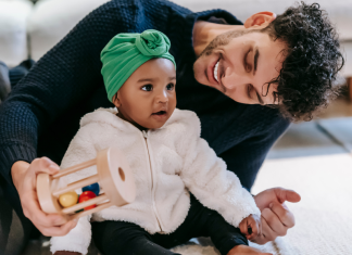 Image: A dad plays with his toddler-aged daughter