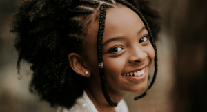 Image: A little girl shows off her smile. Chewable vitamins are better for children's teeth.