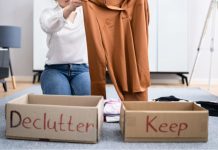 Cleaning and Donating: Give Back Through Decluttering Image: A woman sorts clothing into boxes labeled "declutter" and "keep" as a way to give back