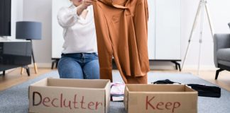 Image: A woman sorts clothing into boxes labeled "declutter" and "keep" as a way to give back