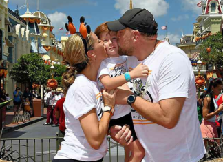 Image: A family poses for a fall-themed photo on Main Street