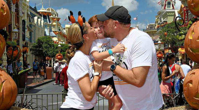Image: A family poses for a fall-themed photo on Main Street