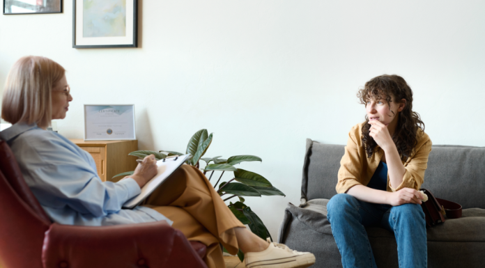 Image: A therapist sitting with a client