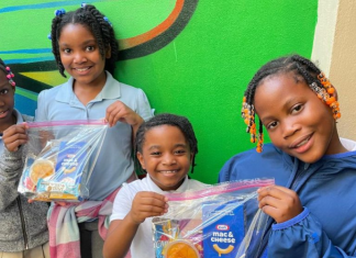Image: Children holding snack packs assembled and distributed by Branches, a local nonprofit in Miami-Dade