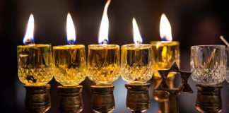 Celebrating Hanukkah: Eight Nights of Traditions Image: Candles lit on Hanukkah menorah