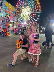 Image: A family poses for a photo at Christmas Wonderland at Tropical Park