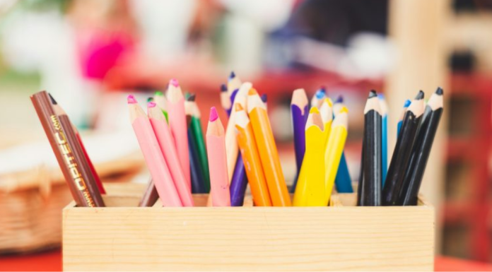 Image: A wooden box of art supplies on a table
