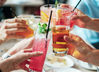 Image: A group of people doing cheers with alcoholic beverages