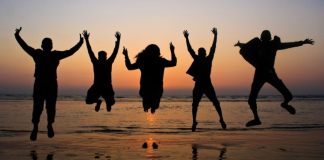 Friends: The Importance of Friendships in Motherhood Image: A group of friends jumping in the air for a photo