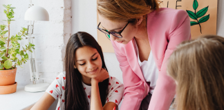 Showing Gratitude: The Importance of Teacher Appreciation Week Image: A teacher helping her students