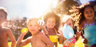 Summer Fun for Kids: 9 Activities to Keep Them Entertained Image: Children holding water balloons