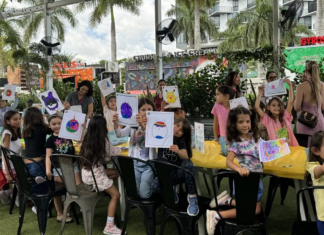 Image: Children at Miami Mom Collective's Comic Kids event hold up pictures of their squish mallows