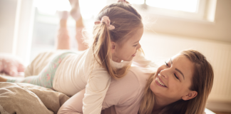 Self-Compassion: A Guide for Working Parents Image: A mom and daughter having fun together
