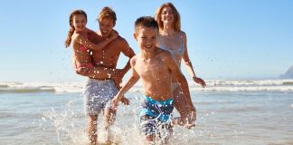 Image: A family playing in the surf at the beach
