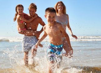 Image: A family playing in the surf at the beach