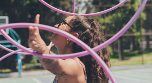 Image: A woman juggles several hula hoops