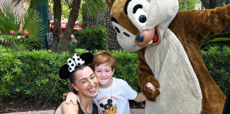 Image: A mother and son pose for a photo with Chip and Dale