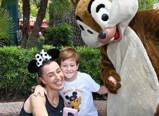 Image: A mother and son pose for a photo with Chip and Dale