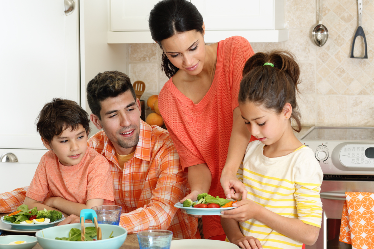 Family enjoying food and drink at dinner