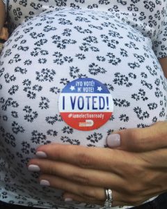 Image: A expectant mom flaunts a Miami-Dade I Voted sticker on her baby bump
