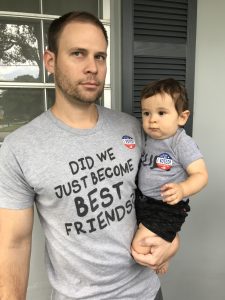 Image: A father and his infant son wear matching "I voted" stickers