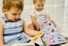 Two toddlers reading