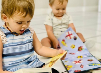 Two toddlers reading