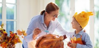 Thanksgiving Festivities: How to Include Your Little Ones Image: A grandmother bastes a Thanksgiving turkey with a grandchild