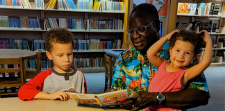 Visiting the Dentist: 15-ish Books for Kids | Dr. Bob Image: A grandfather reads books to his grandchildren at the library