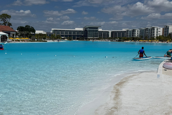 Image: A guest takes a paddleboard out on the lagoon